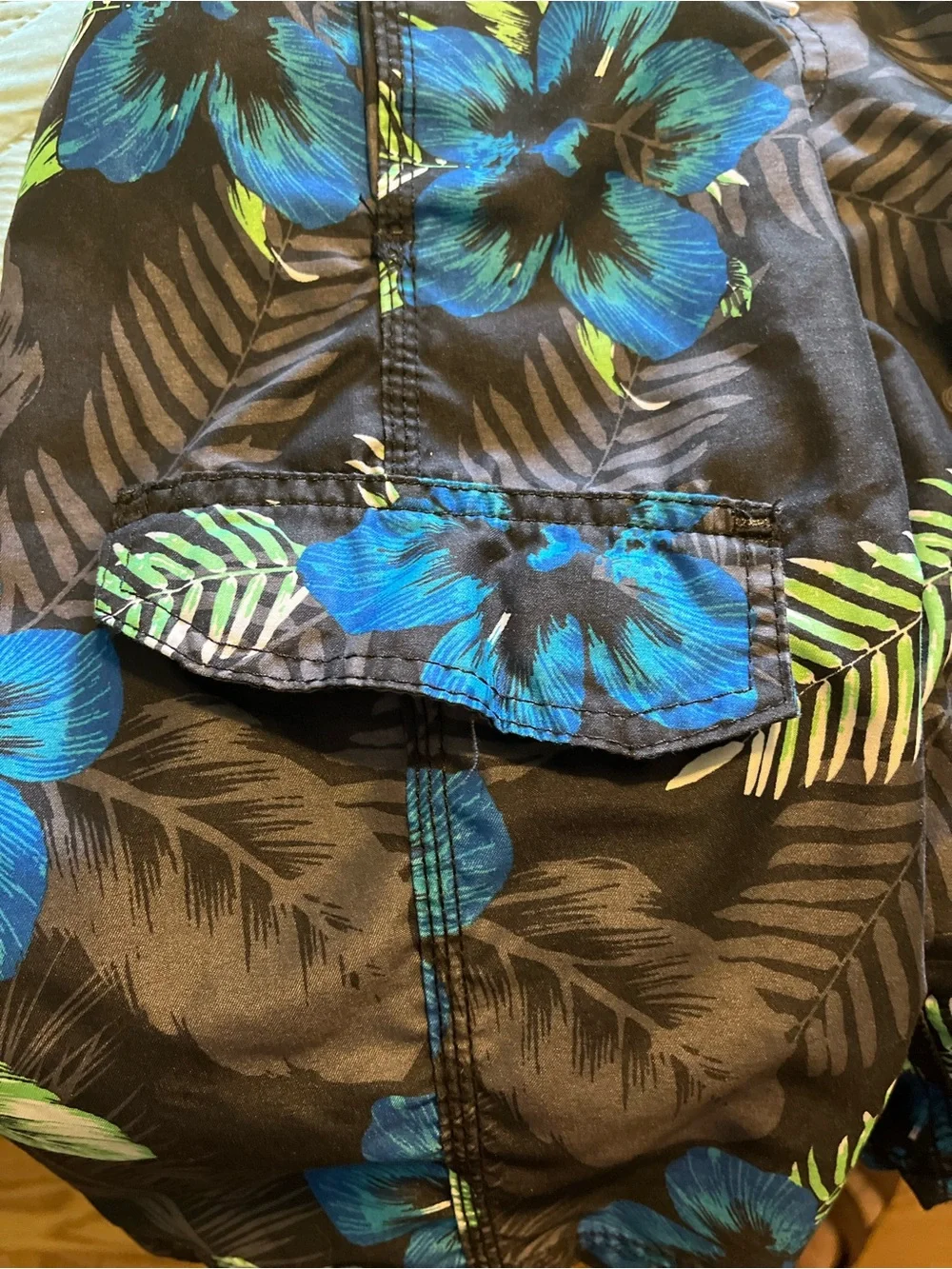 Pair of Kanu Surf Men's Blue Camo & Black Floral Swim Trunks